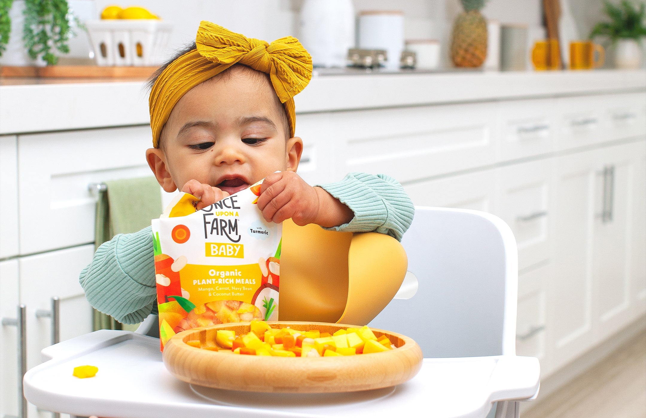 Baby feeding deals himself spoon