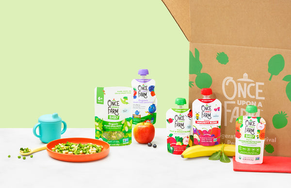 Once Upon a Farm Plant-Rich Meal and baby food pouches, next to a subscription box on a green background