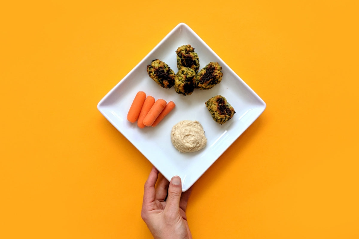 Pea & Zucchini Tots made with Once Upon a Farm frozen meal and served with a side of carrots and ranch. 
