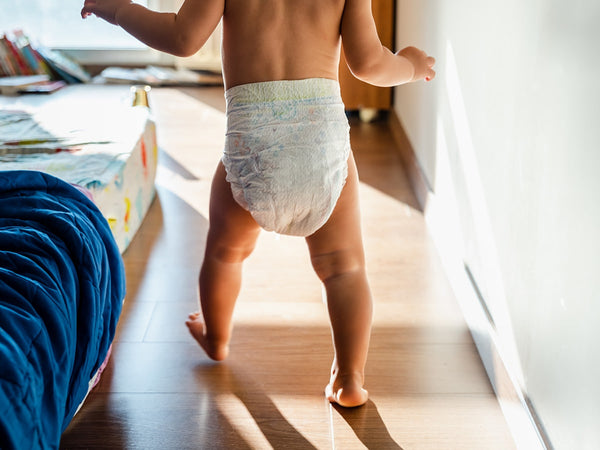 baby wearing a diaper and walking 