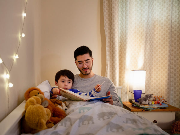 dad reading a bedtime story to his child