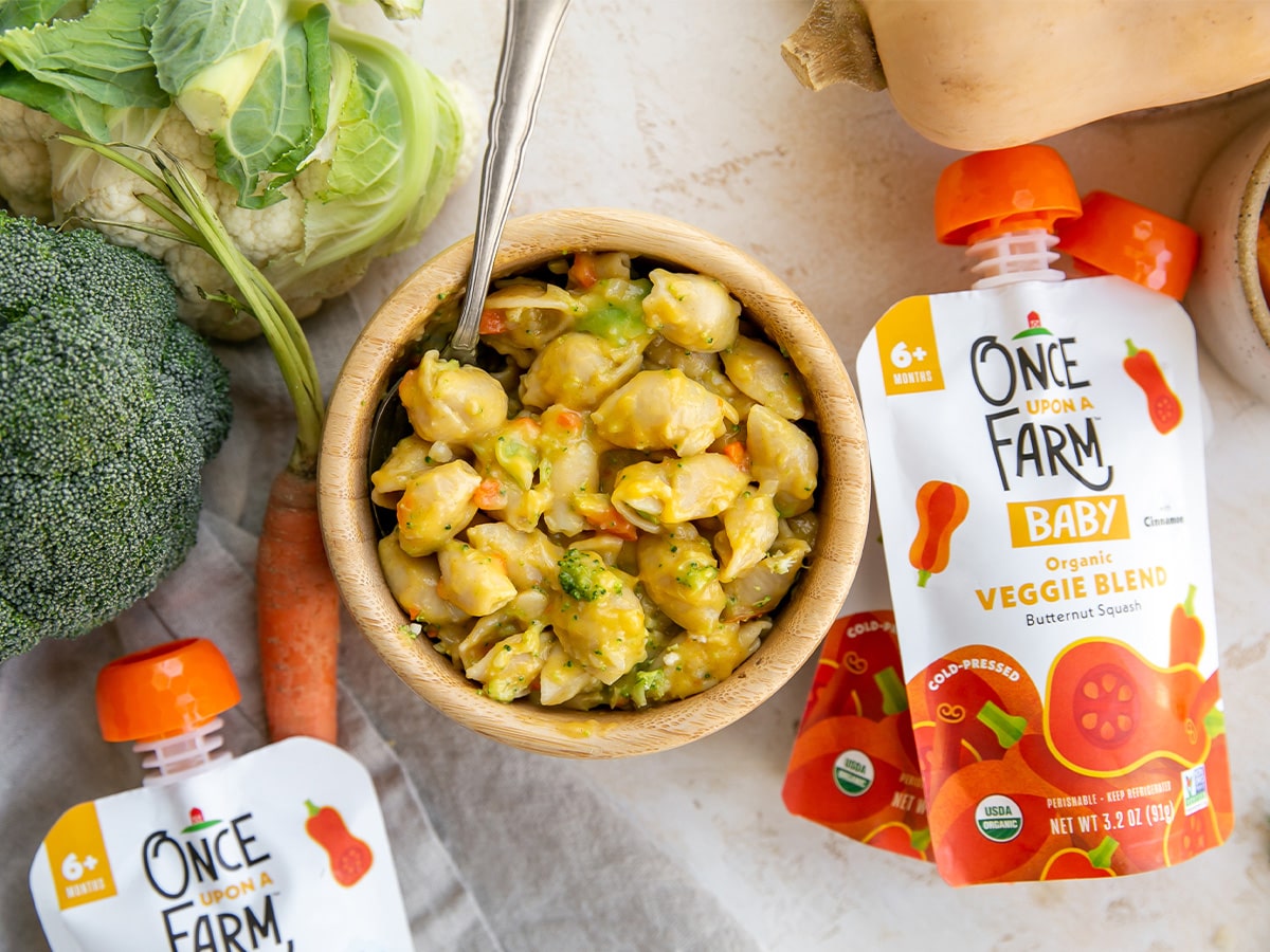 butternut squash mac and cheese in a bowl, surrounded by Once Upon a Farm Butternut Squash Veggie Blend pouches