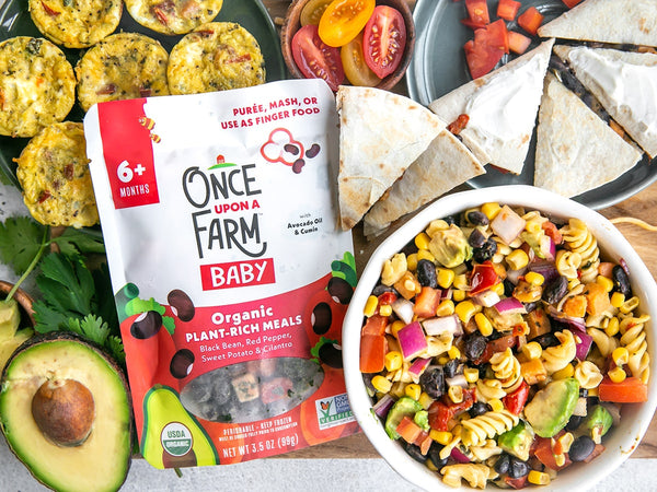 once upon a farm black bean red pepper meal, alongside pasta salad, a quesadilla, and egg bites