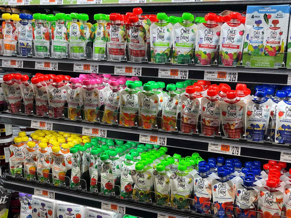 once upon a farm kids' snack pouches and baby food pouches on shelves in a grocery store