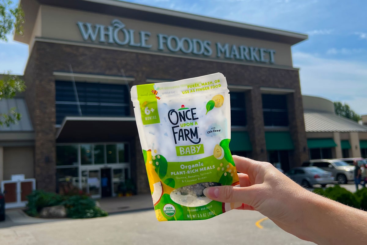 once upon a farm organic baby food meal in front of whole foods market store