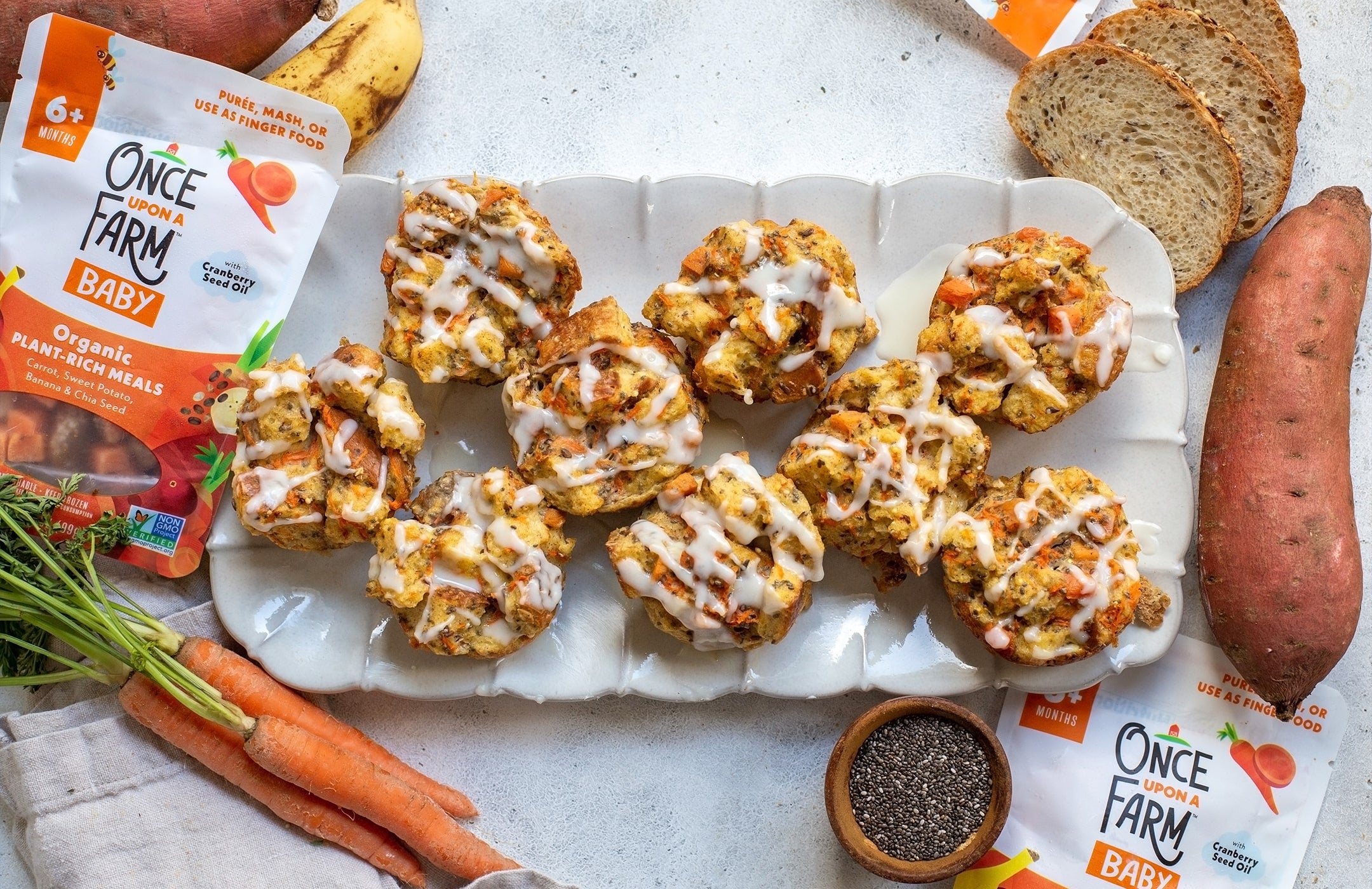 carrot cake French toast cups on a serving plate, surrounded by fresh ingredients