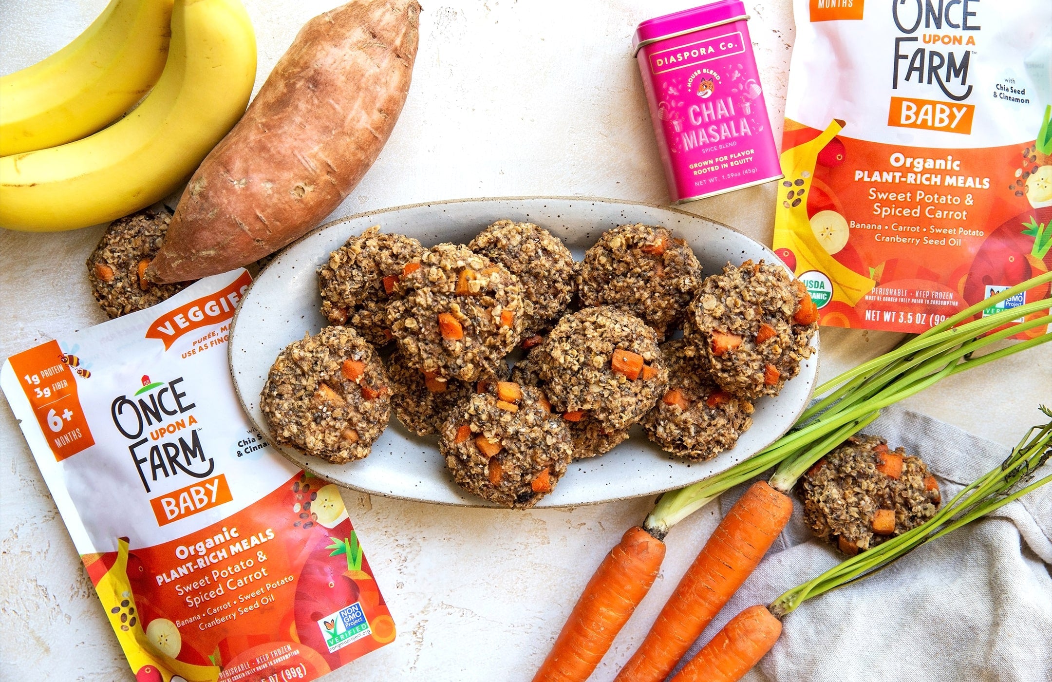 Chai-spiced breakfast cookies on a plate, surrounded by the ingredients used to make them