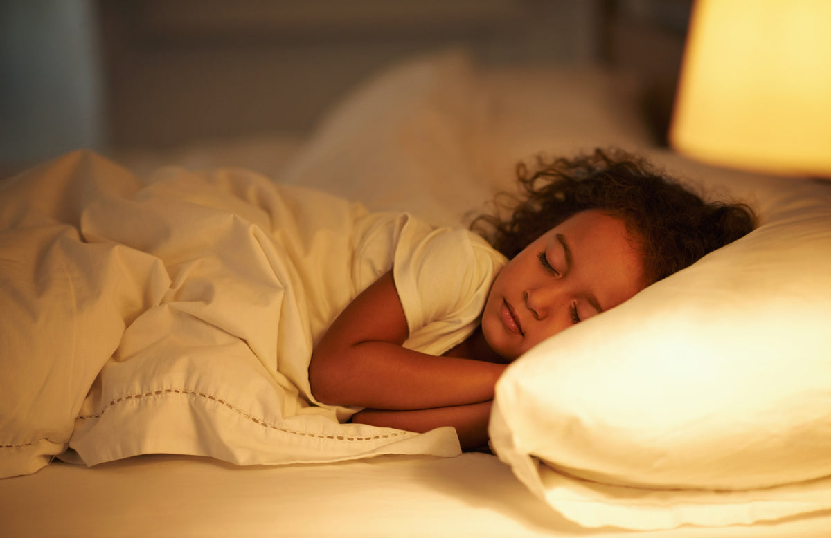 young girl sleeping in bed