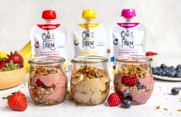 three jars with parfaits, in front of three Once Upon a Farm Dairy-Free Coconut Yogurt Alternative pouches