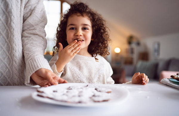 girl eating holiday cookies