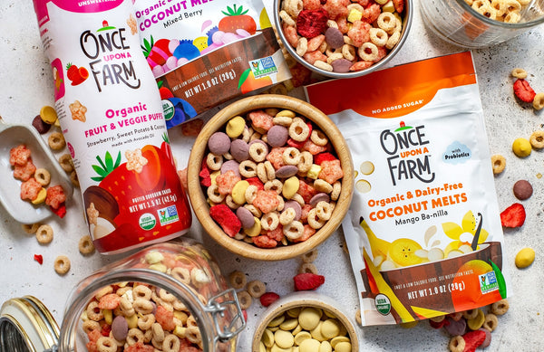 toddler trail mix in a bowl, surrounded by Once Upon a Farm baby and toddler pantry snacks