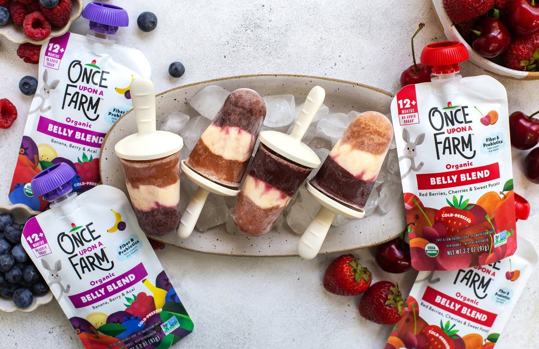 PB&J ice pops on a serving tray, next to Once Upon a Farm Belly Blends pouches