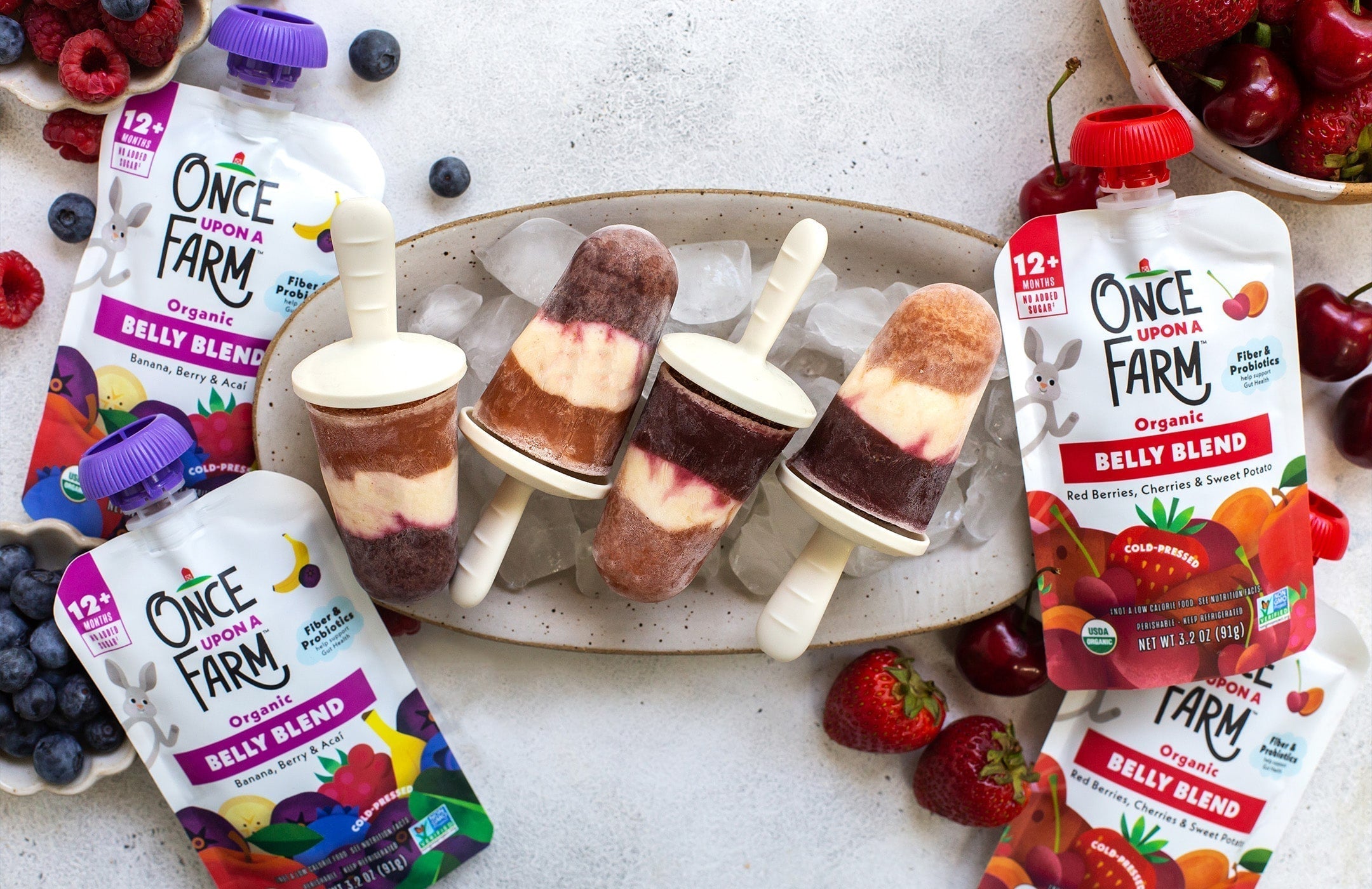 PB&J ice pops on a serving tray, next to Once Upon a Farm Belly Blends pouches