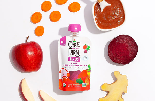 Once Upon a Farm Baby Fruit & Veggie Blend purée pouch, surrounded by fresh fruits and veggies