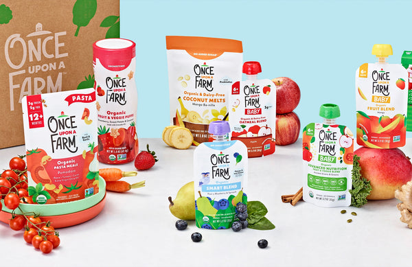 assortment of Once Upon a Farm baby food items, next to a subscription box