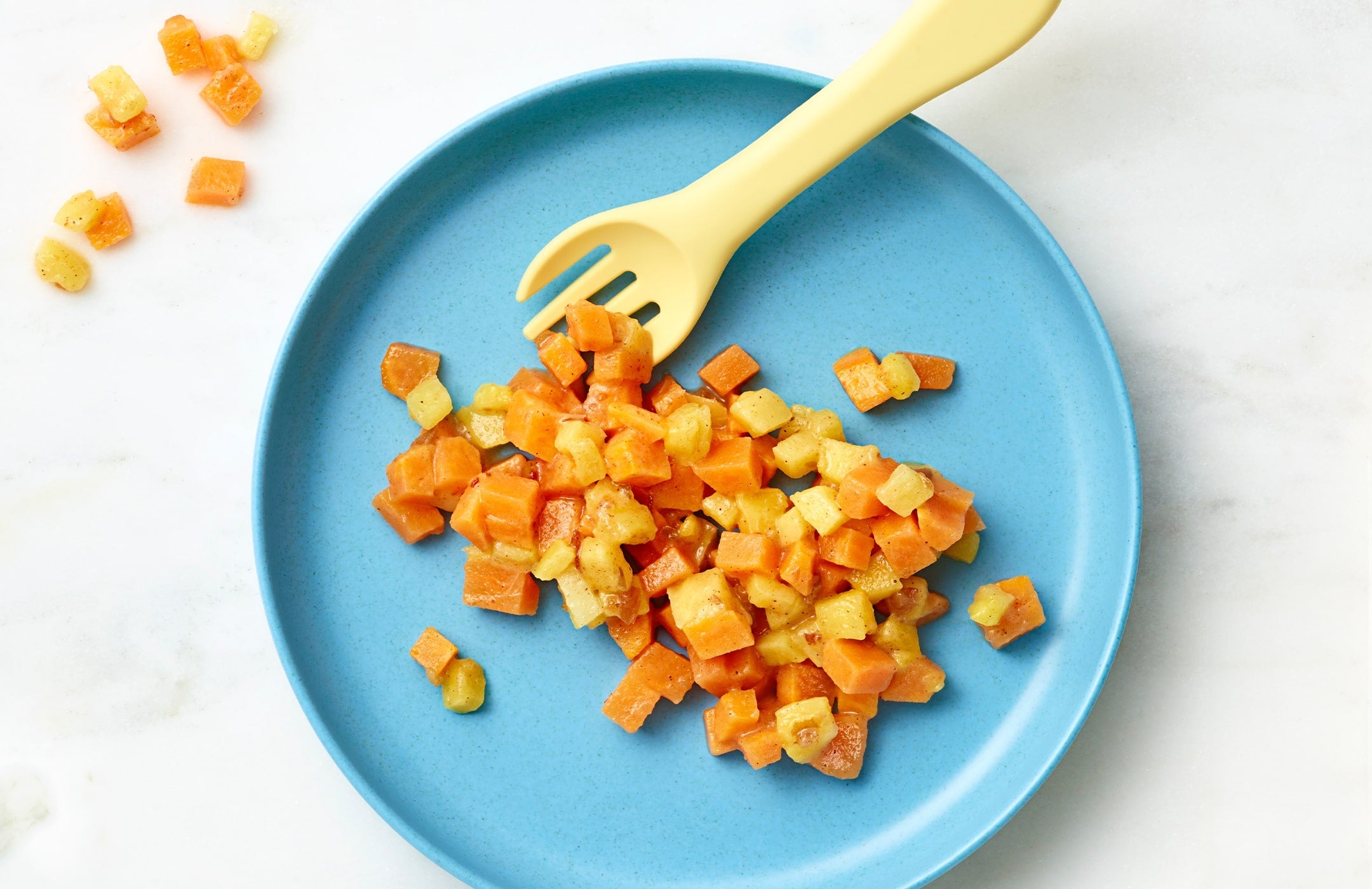 Once Upon a Farm Sweet Potato, Mango & Coconut Milk Plant-Rich Meal on a blue plate with a yellow fork