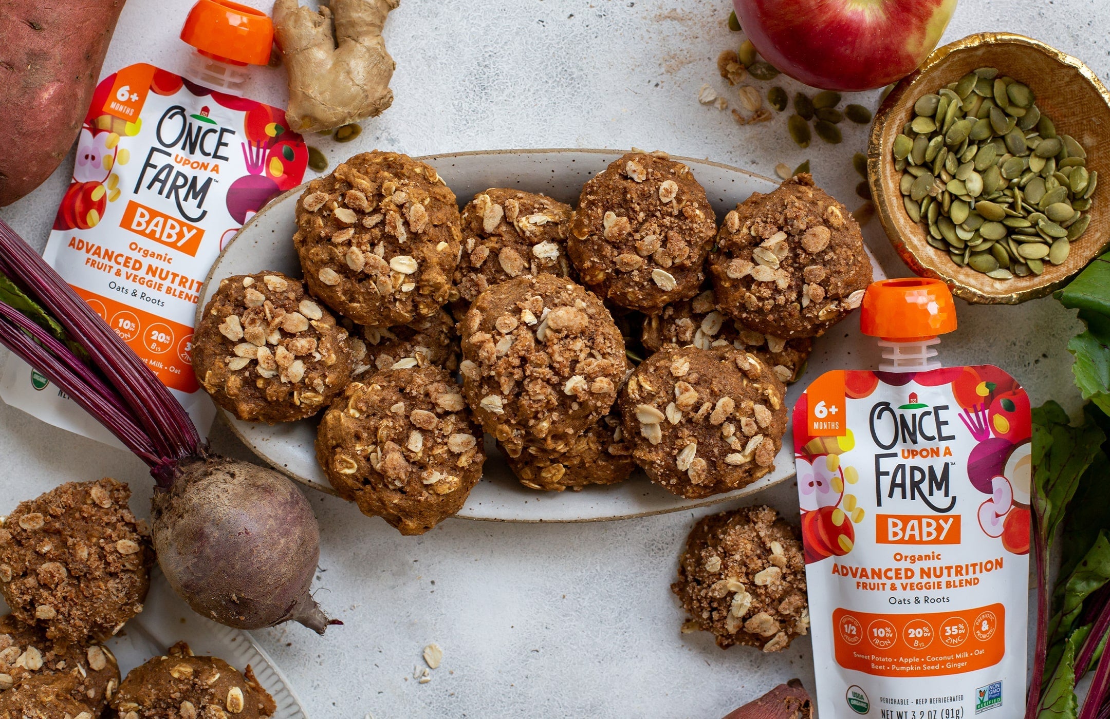 sweet potato pie cookies on a serving plate, surrounded by fresh ingredients and Once Upon a Farm pouches