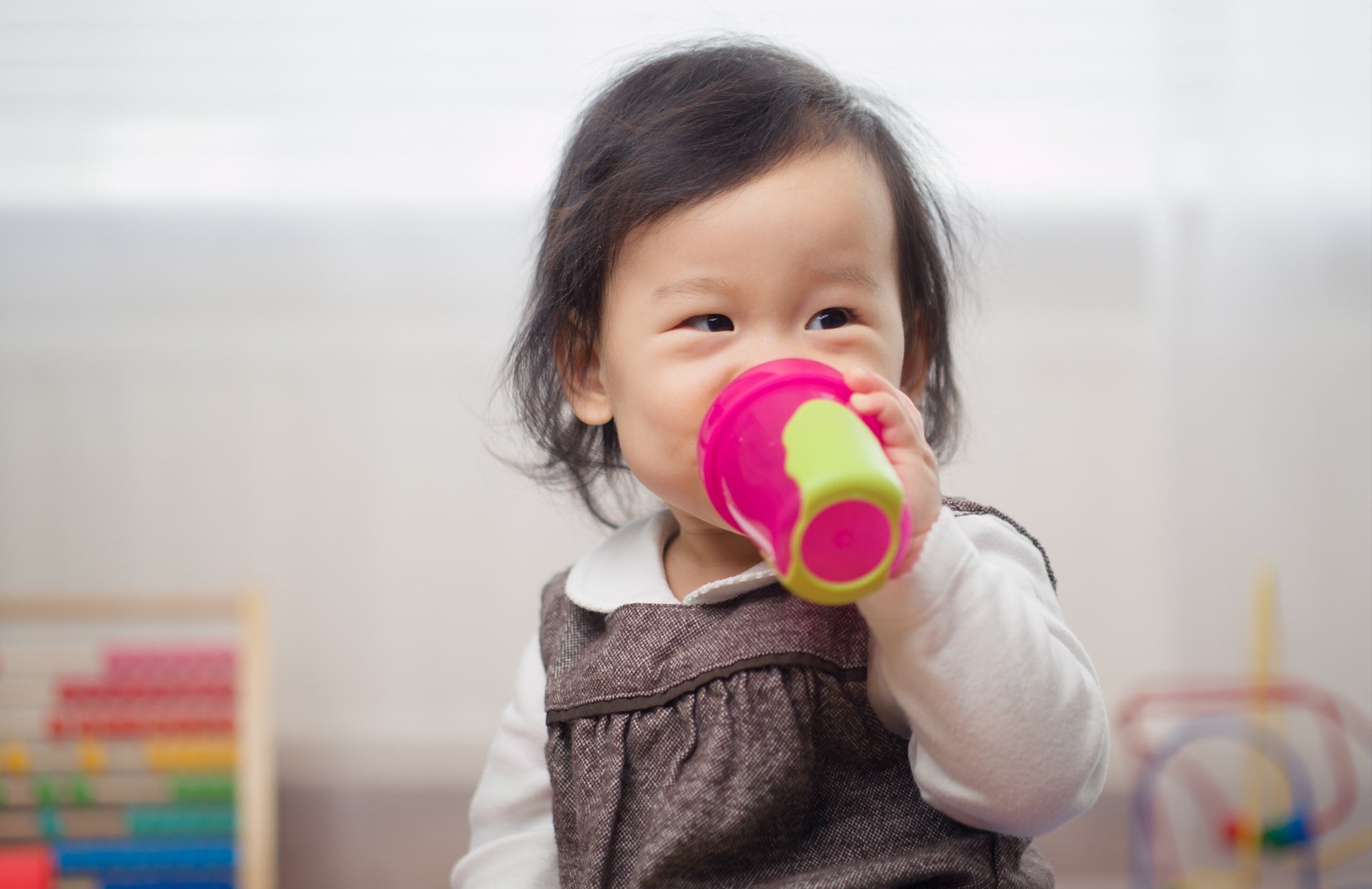 toddler drinking from a sippy cup