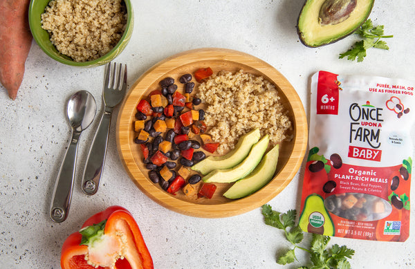 Once Upon a Farm Black Bean & Red Pepper Meal, plated with quinoa and sliced avocado