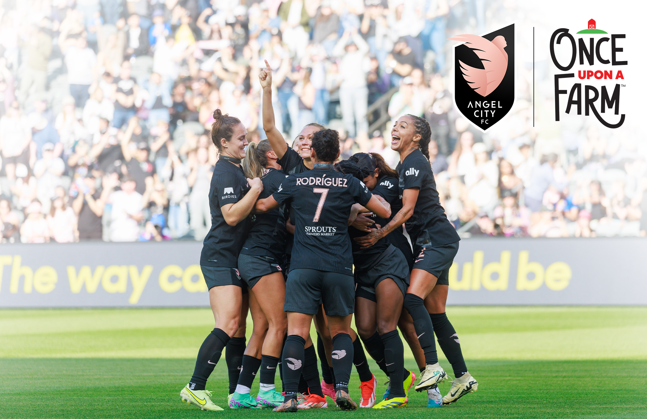 Angel City Football Club team celebrating on the field after a win, with ACFC and Once Upon a Farm logos on the image