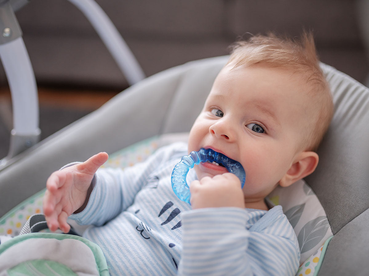Teething baby chewing on a teething toy.