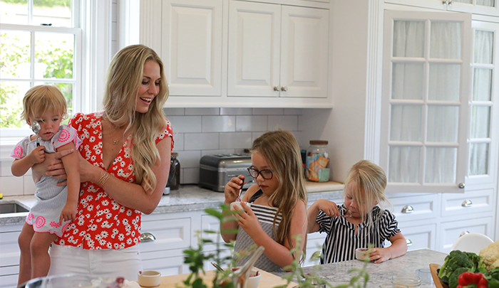 Co-founder Cassandra Curtis and children in the kitchen testing the Green Kale & Apples blend recipe.