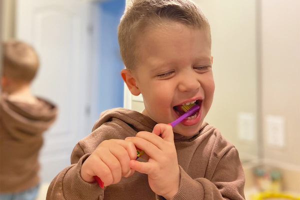 close-up of a toddler brushing his teeth 