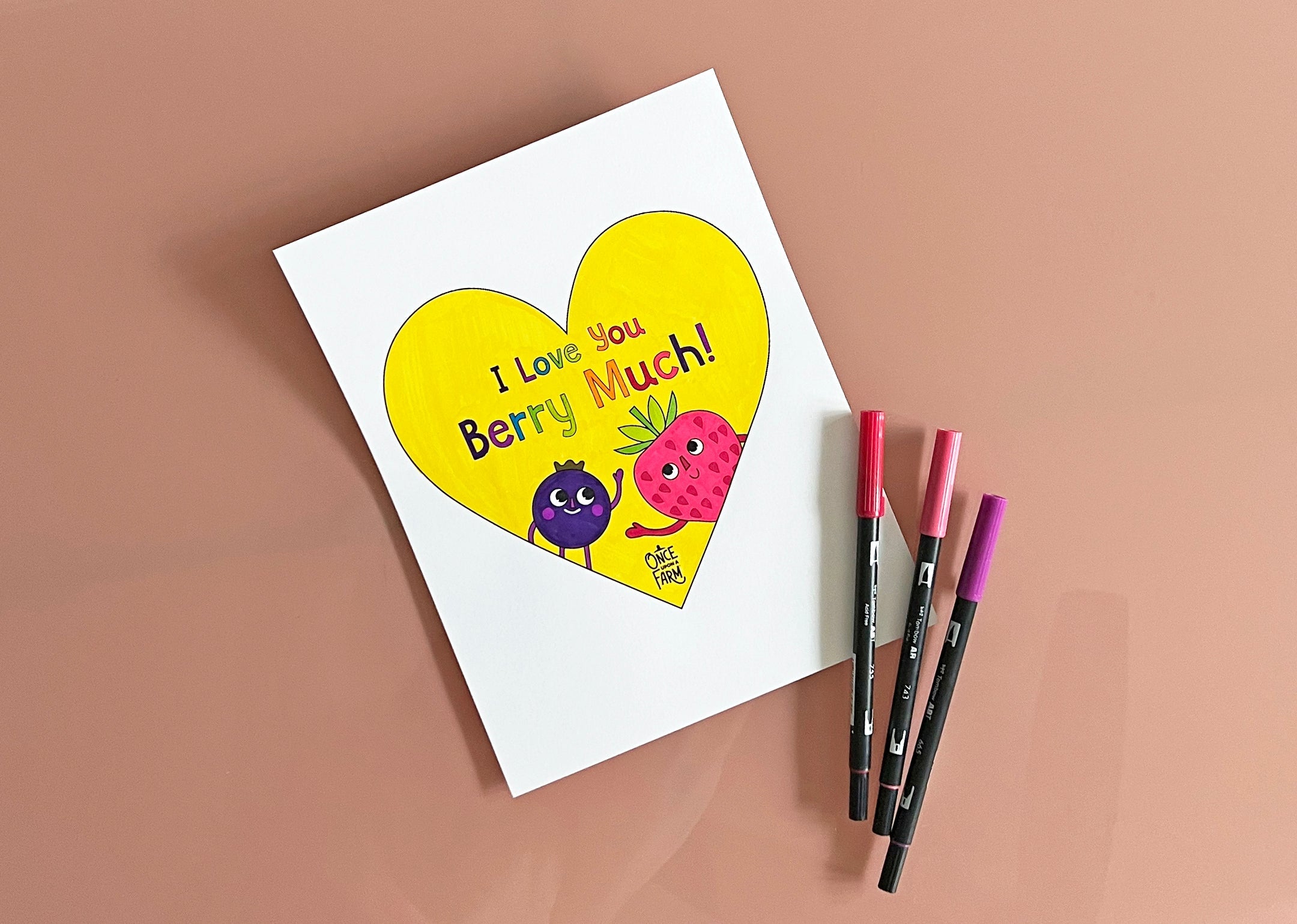 Completed coloring sheet of a heart with two berries, featuring the words, "I love you berry much!"