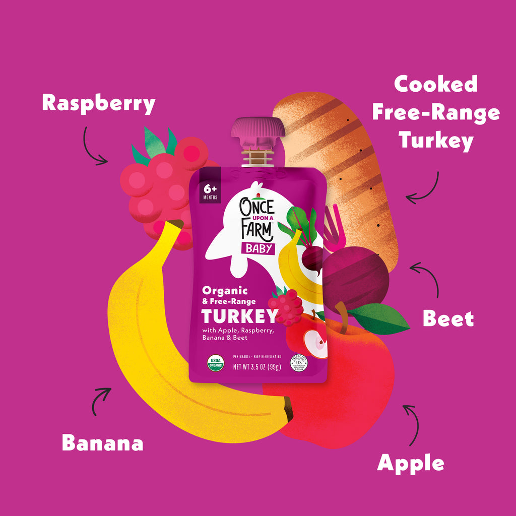 Once Upon a Farm Baby organic Apple, Turkey, Raspberry & Banana pouch with fruits and vegetables on a purple background