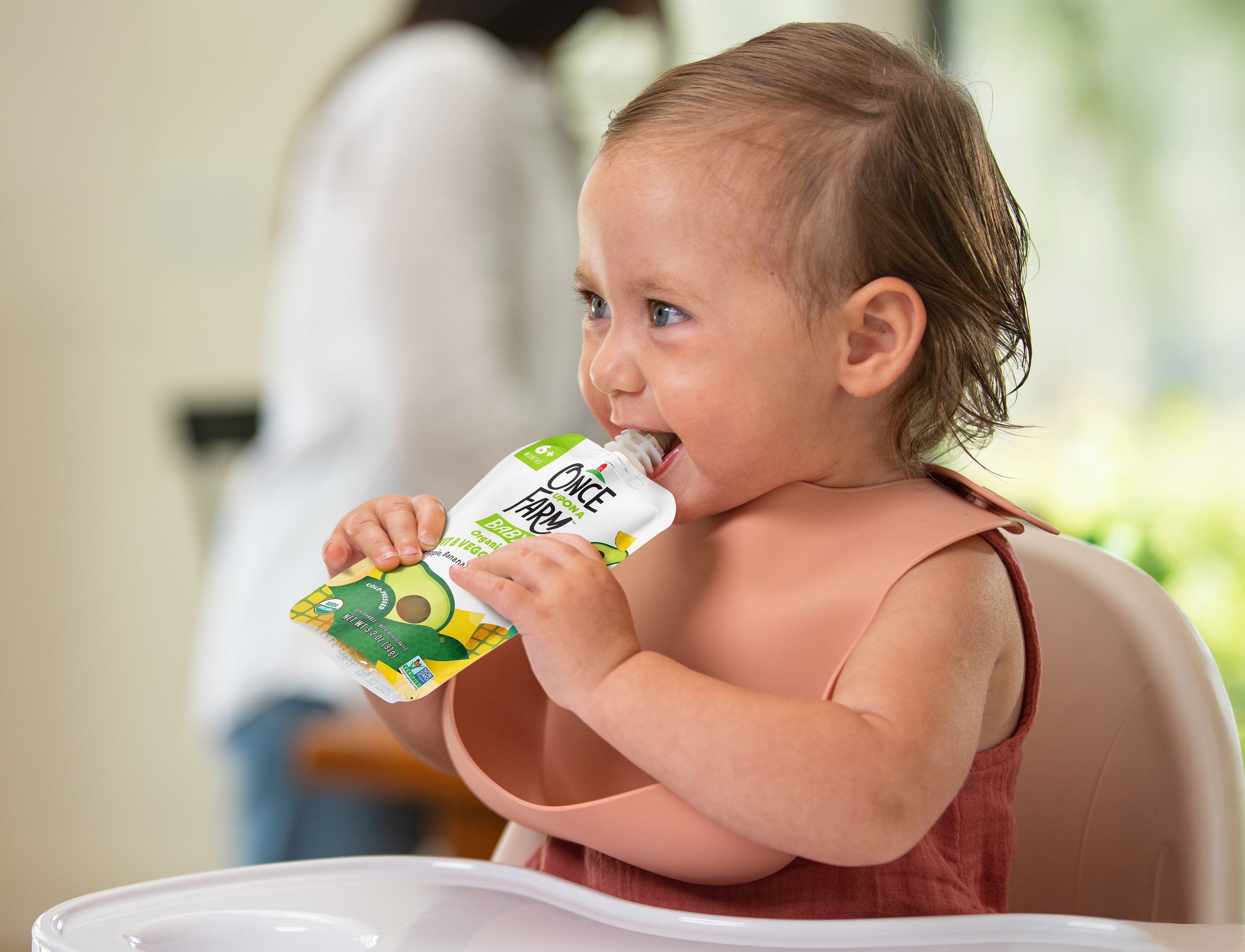 Photo of Baby Eating A Once Upon a Farm Pouch
