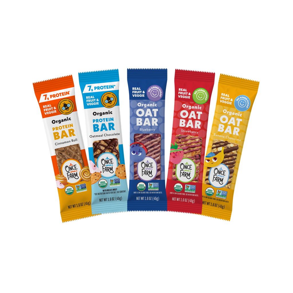 Five 1 Protein Organic Oat Bar packages arranged in a fan shape on a plain white background. The packages are in different colors: orange, light blue, dark blue, red, and yellow, each showing a different flavor with illustrations of snacks and the Once Farm logo.